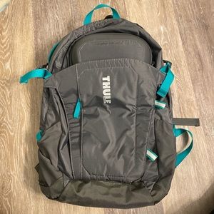 Thule backpack grey and green with adjustable buckles and pockets